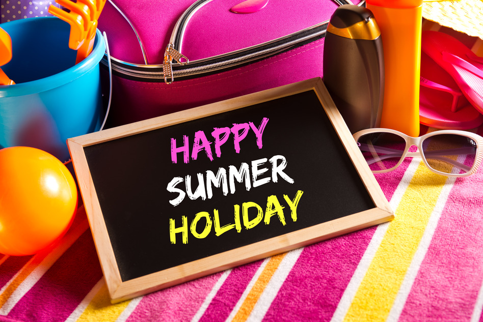 Happy summer holidays card with colorful text on blackboard.